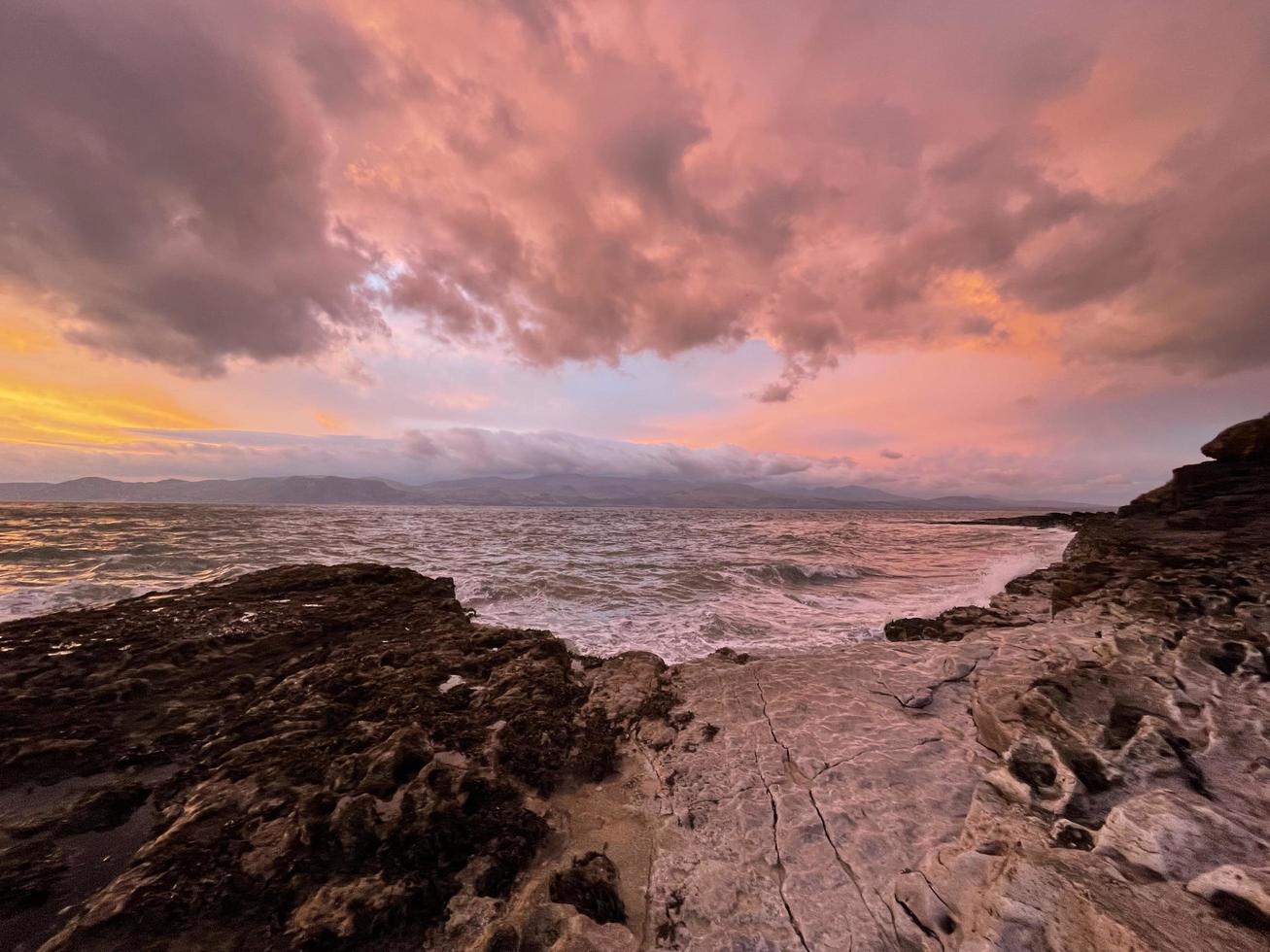 A sunrise with an array of wild and beautiful colours at the famous Penmon Point in North Wales photo
