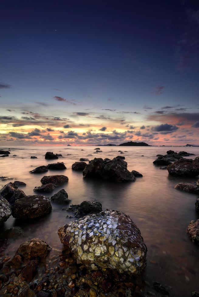 Beautiful seascape. Sea and rock at the sunset. Nature composition. photo
