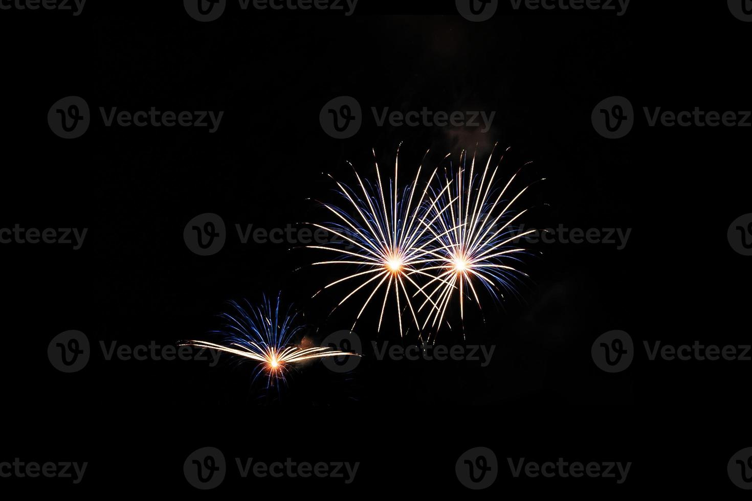 Abstract colored firework background light up the sky with dazzling display photo