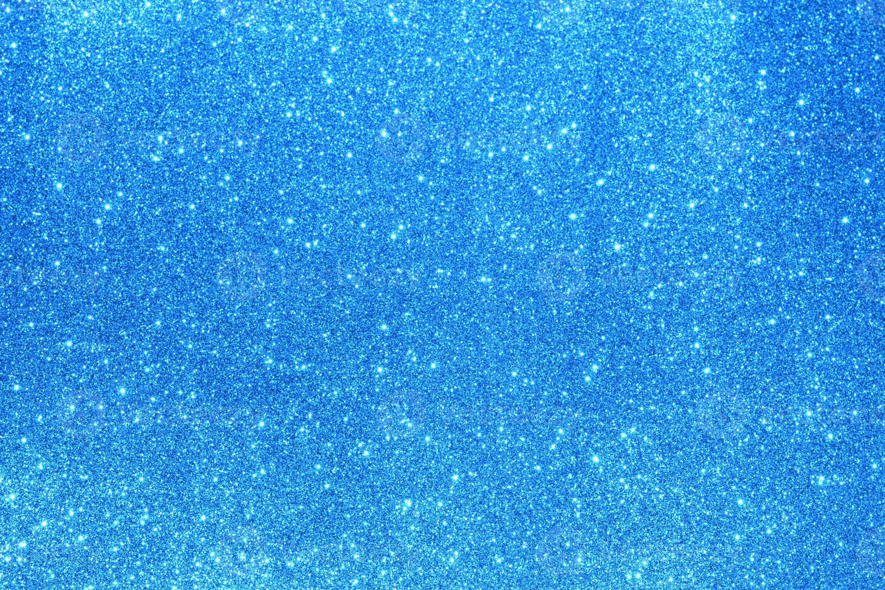 Light blue glitter background. Texture of light blue glitter particles