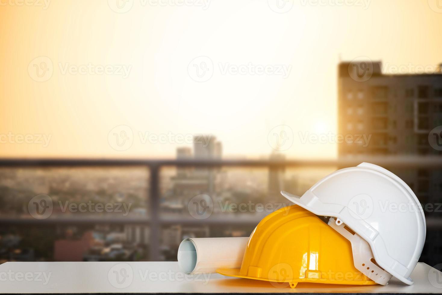Construction house and building. Repair work. Drawings for building and helmet on white table. photo