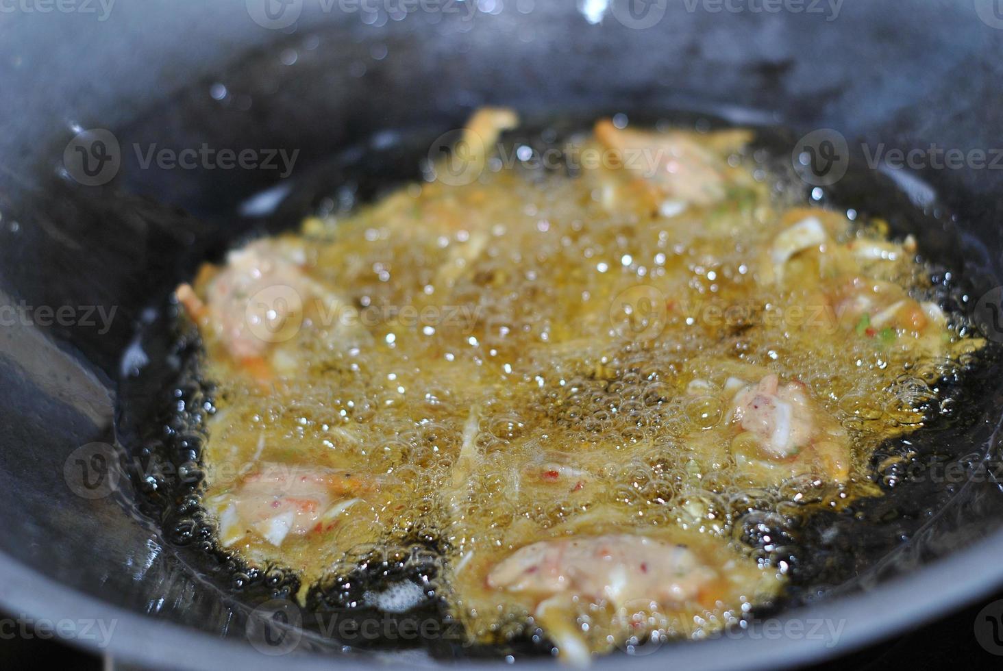 Closeup of frying bakwan on a frying pan. Typical traditional snacks of Asian Indonesian people. photo