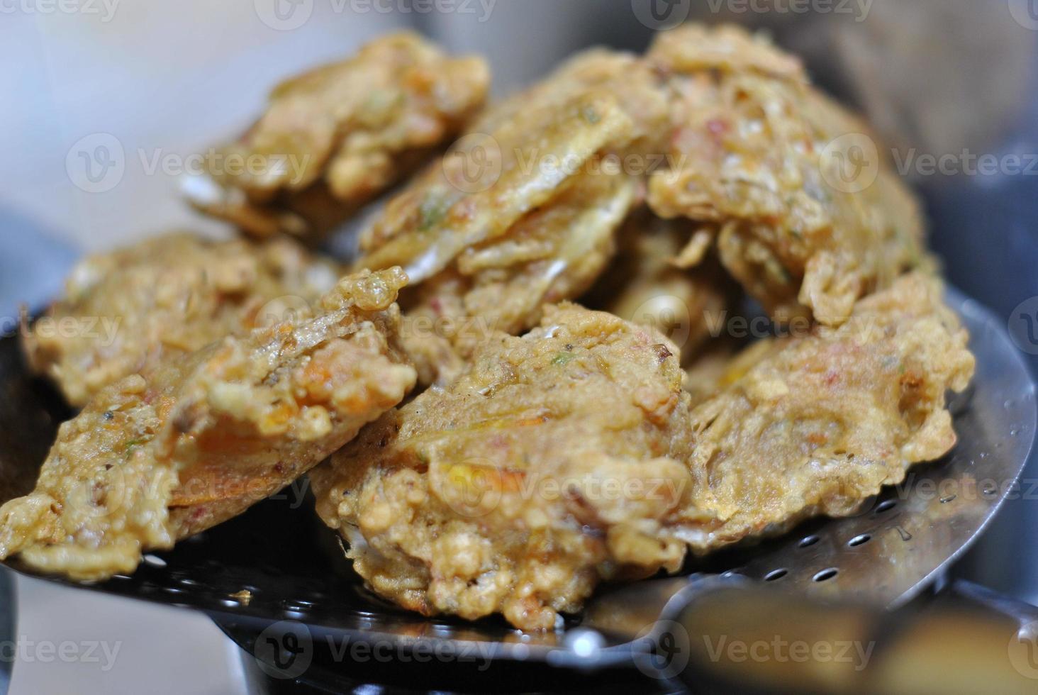 Bakwan is typical traditional snacks of Asian Indonesian people. The ingredients are vegetables, usually, shredded cabbages and carrots, battered and deep fried in cooking oil. photo