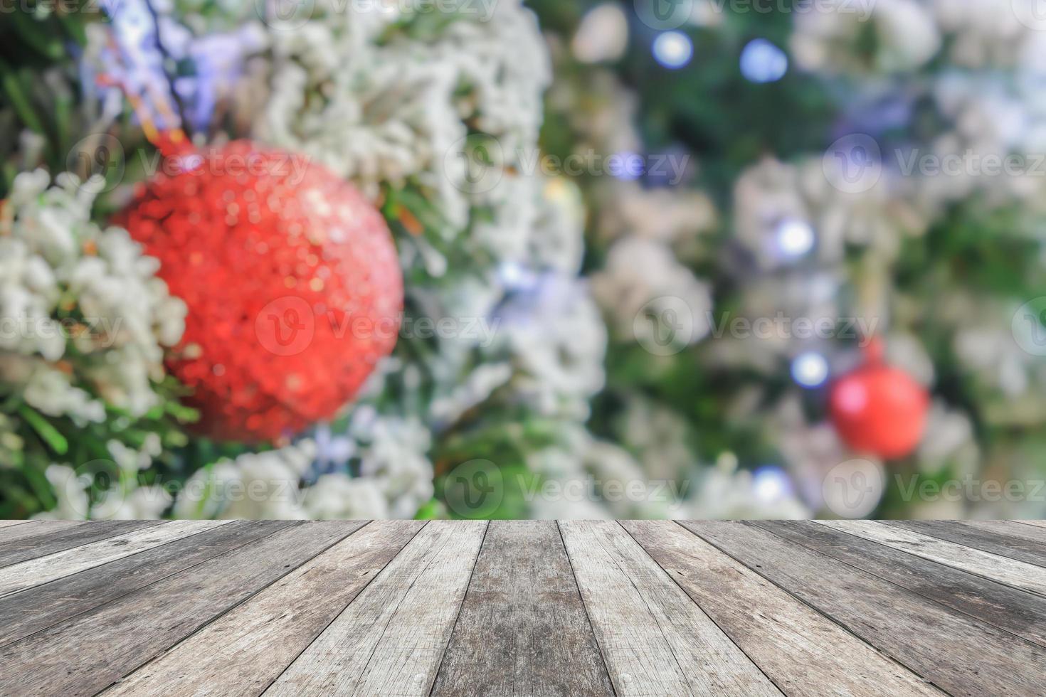 Empty wood table top with blur Christmas tree with bokeh light background photo