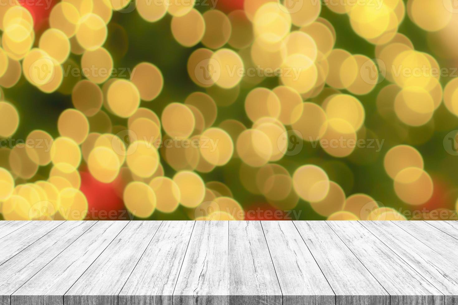 Empty wood table top with blur Christmas tree with bokeh light background photo