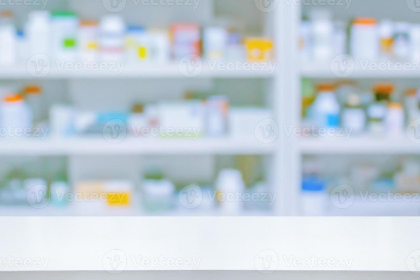 Empty white counter with pharmacy drugstore shelves blurred background photo