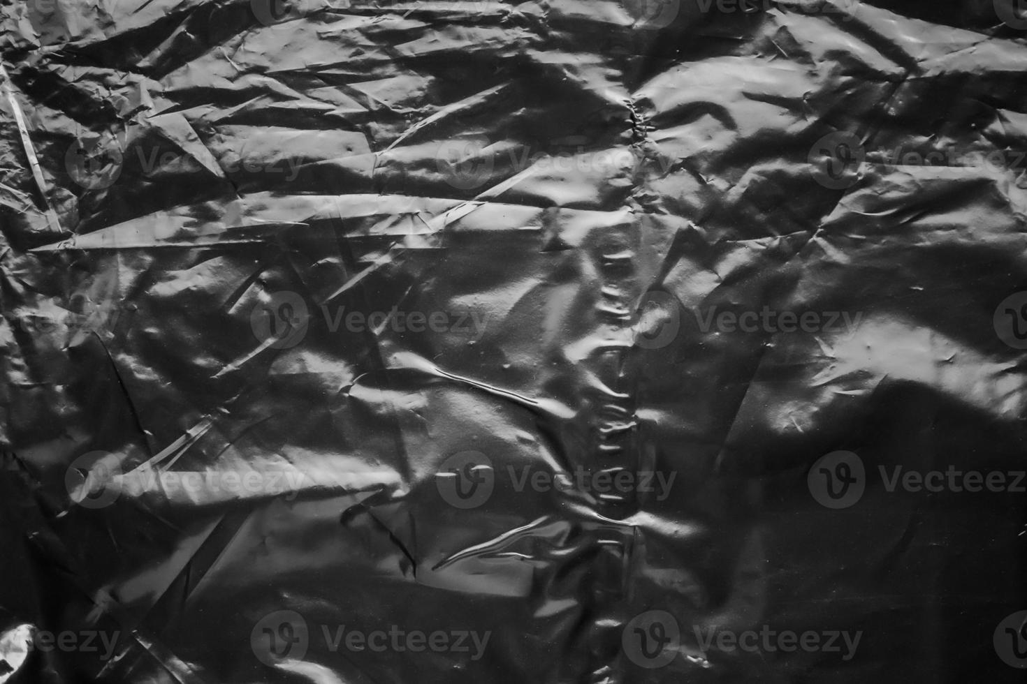 transparent plastic bag wrap overlay texture on black background photo