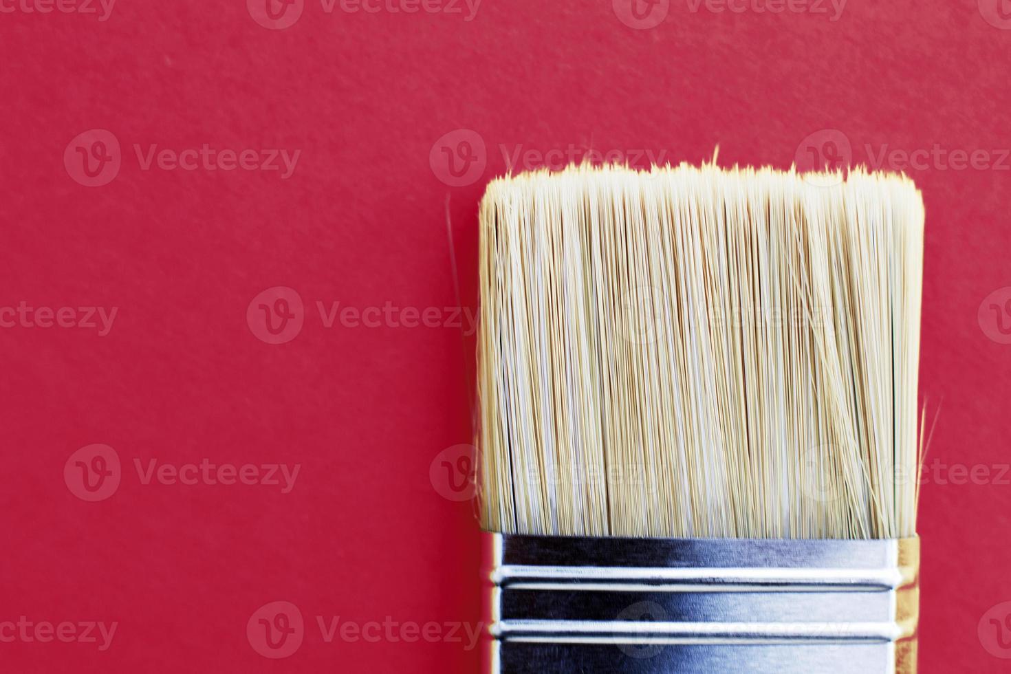 Paint brush isolated on a viva magenta background close with copy space photo