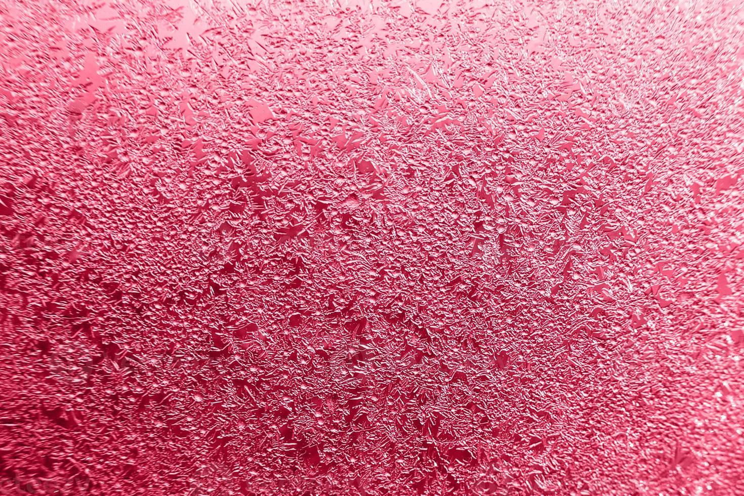 snow pattern on the glass from frost. viva magenta color of the year photo