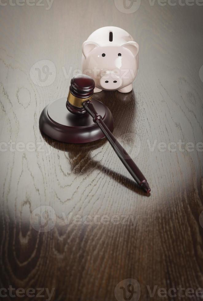 Gavel and Piggy Bank on Table photo