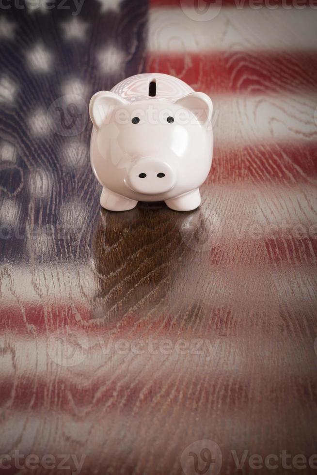 Piggy Bank with an American Flag Reflection on Table photo