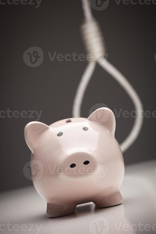 Piggy Bank with Hangman's Noose in Background photo