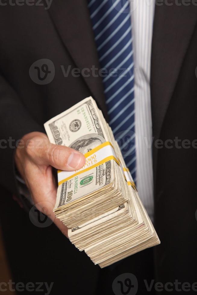 Businessman Handing Over Stack of Cash photo