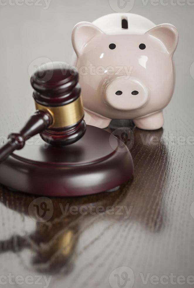 Gavel and Piggy Bank on Table photo