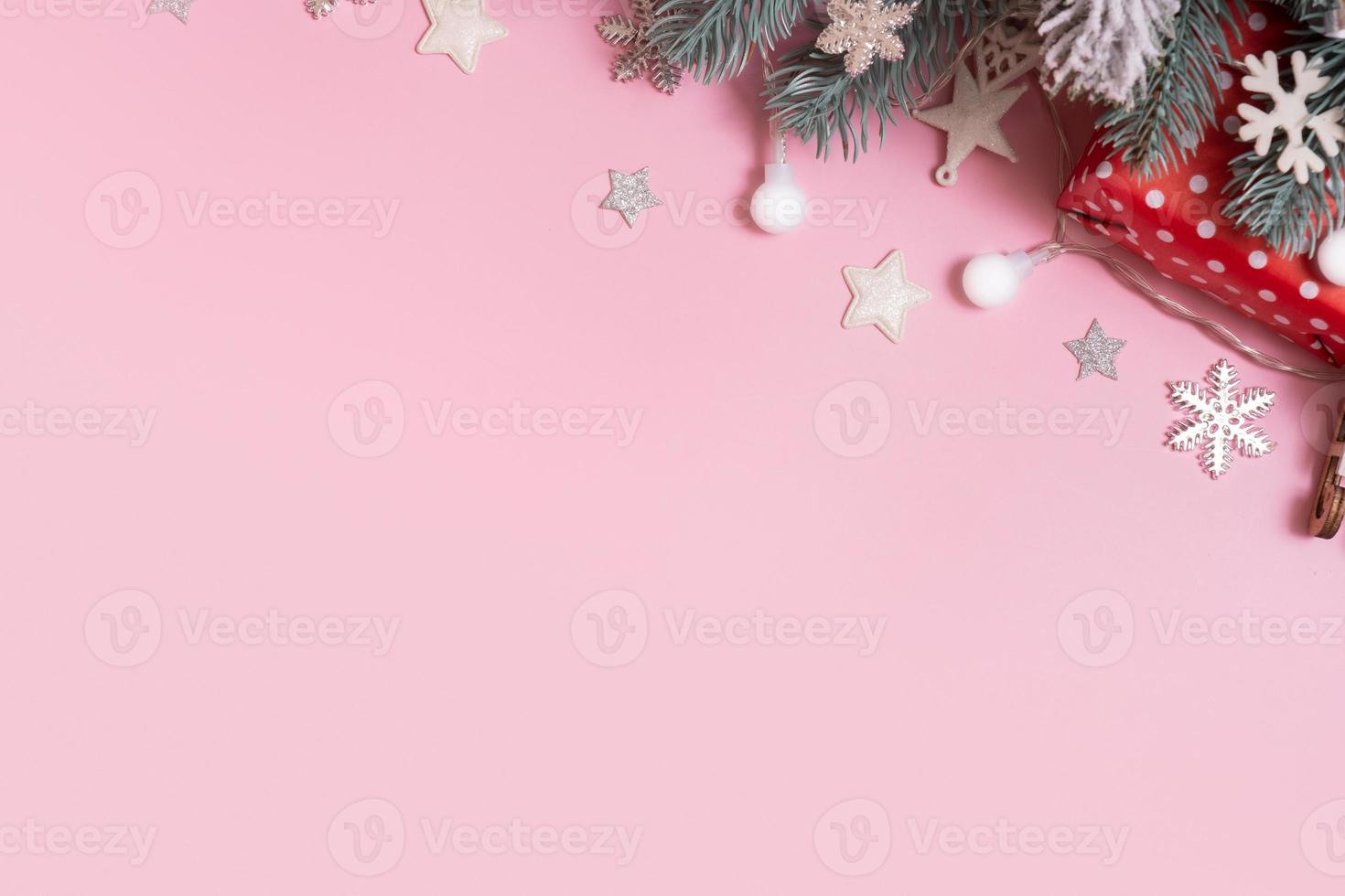 Pine trees branches with Cristmas New Year decoration top view, flat lay on pink background with copy space. Blank greeting card photo