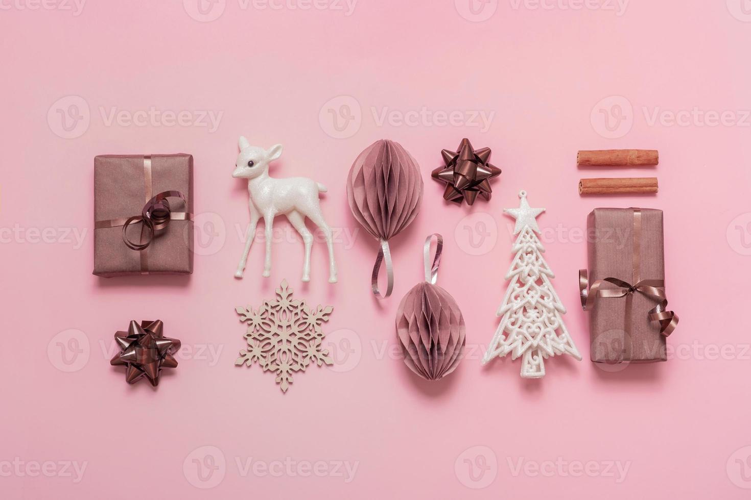 Christmas and Happy new year flat lay composition for greeting card on pink background. Xmas decorations and gifts top view photo