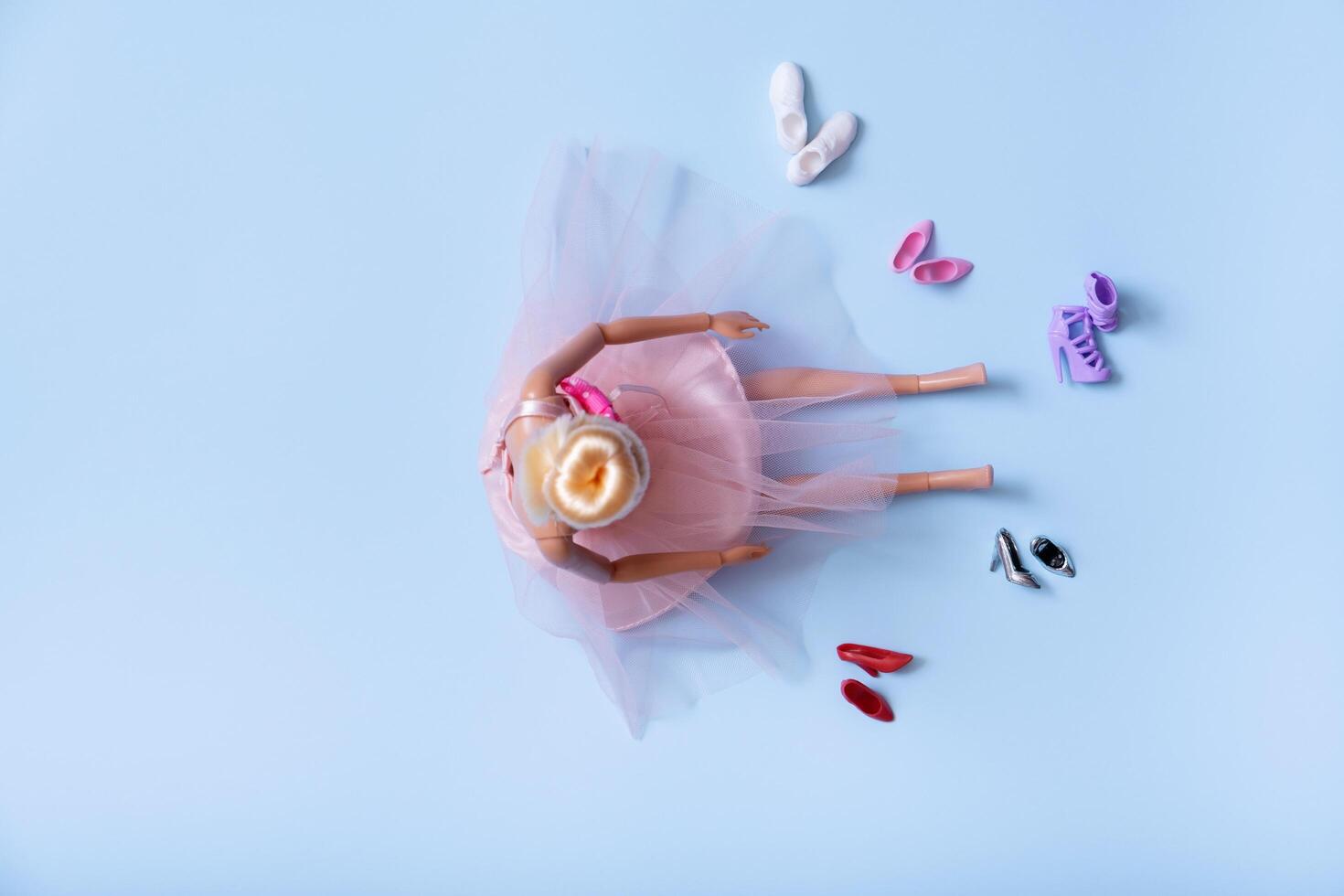 A symbol of choosing women's shoes. The doll and foot wear top view, flat lay photo