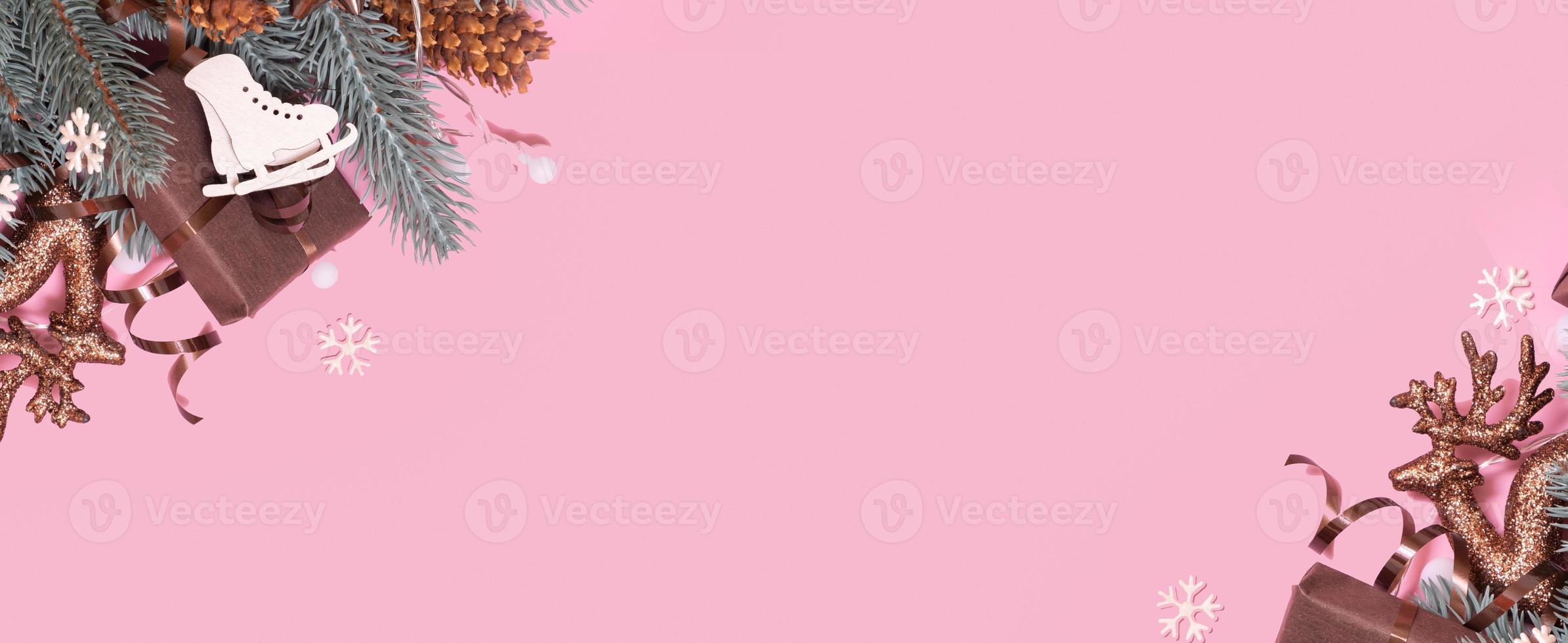 Pine trees branches with Cristmas New Year decoration top view, flat lay on pink background with copy space. Blank greeting card photo