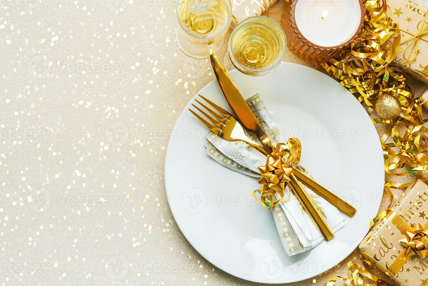 Christmas dinner concept. Top view of golden cutlery on a plate with christmas ornament and space for text photo