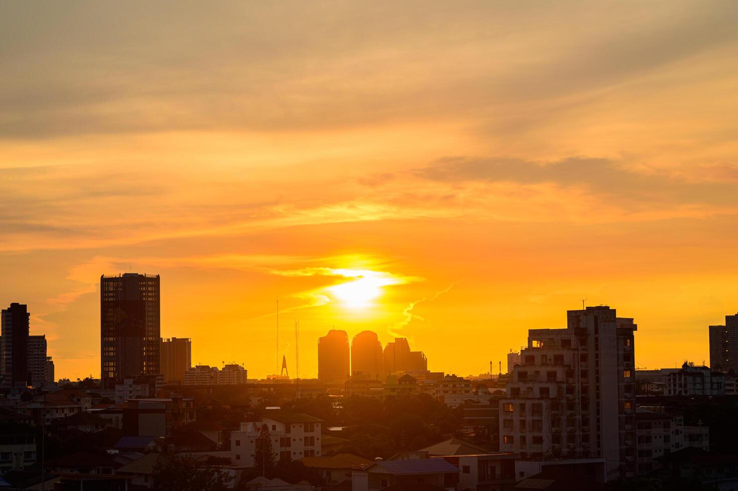 The sun is setting over a city skyline photo