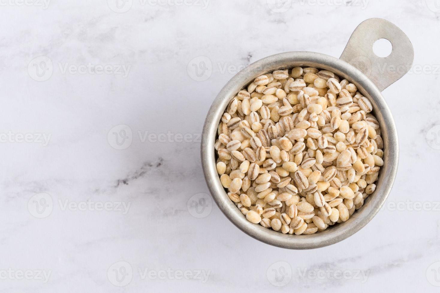 Uncooked Pearled Barley in a Measuring Cup photo