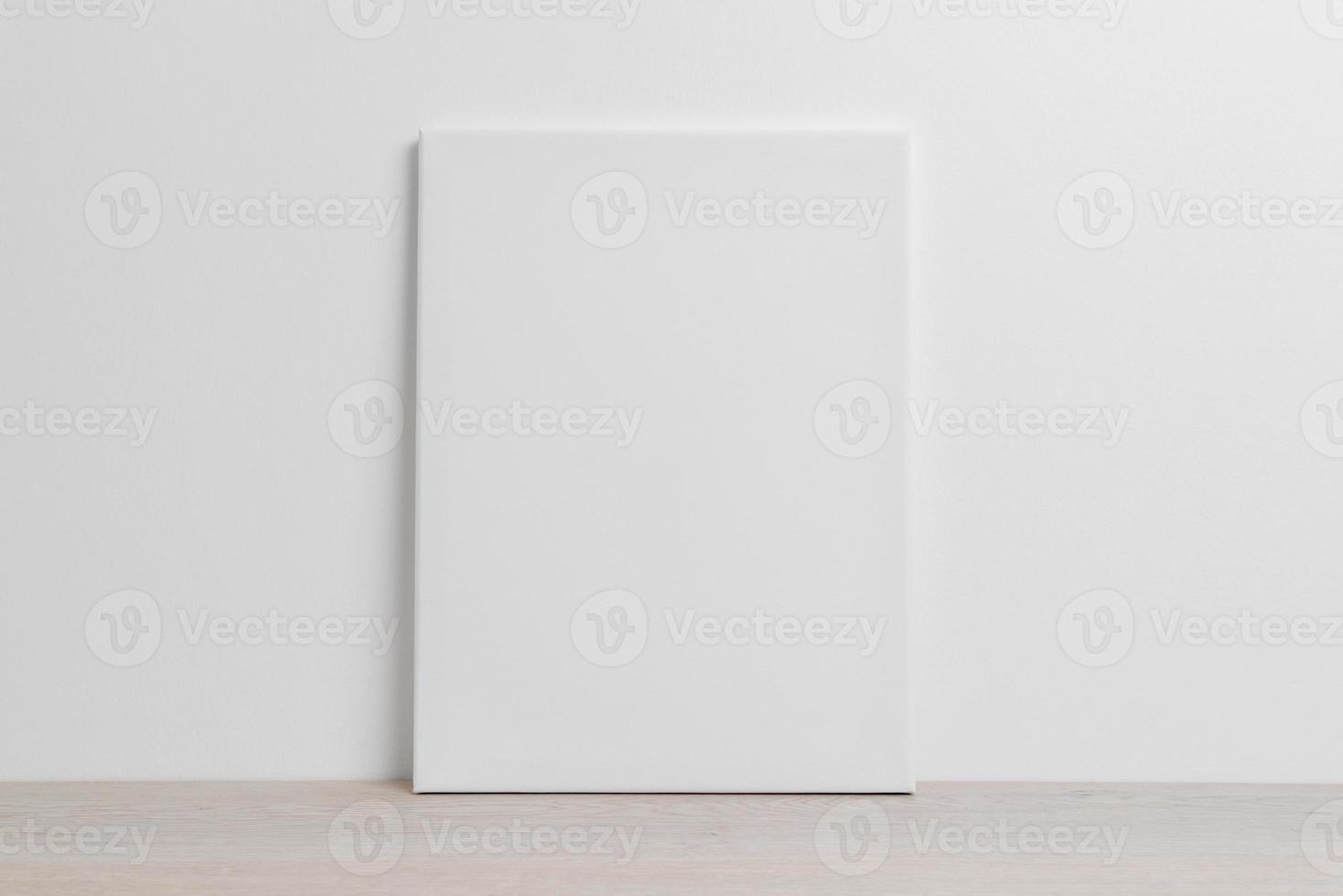 Art canvas mockup on the floor leaning against the white wall photo
