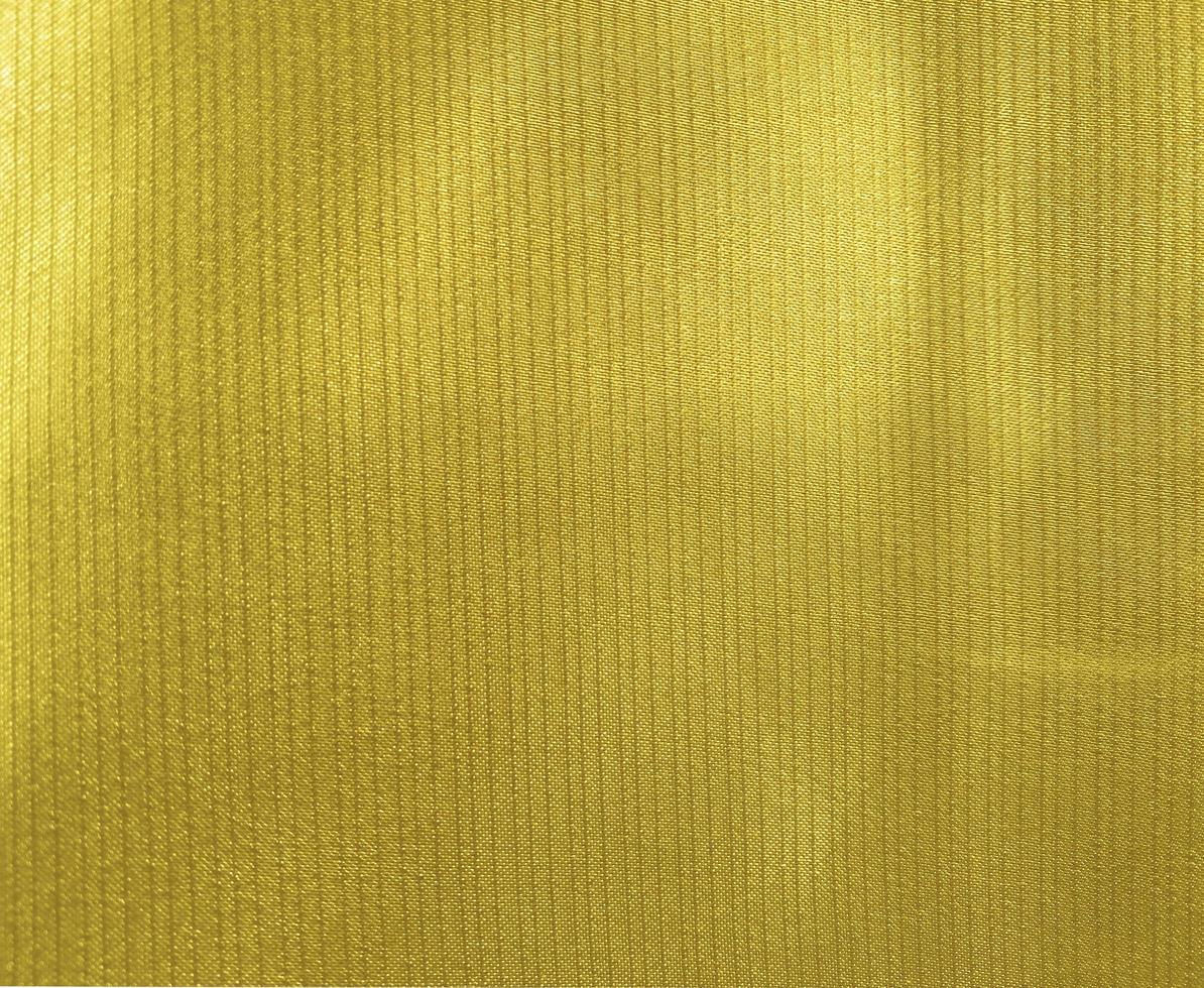 textura de de tela dorada utilizada como fondo. fondo de tela tela dorada vacía de material textil suave y liso. hay para el texto. 15233596 Foto de stock