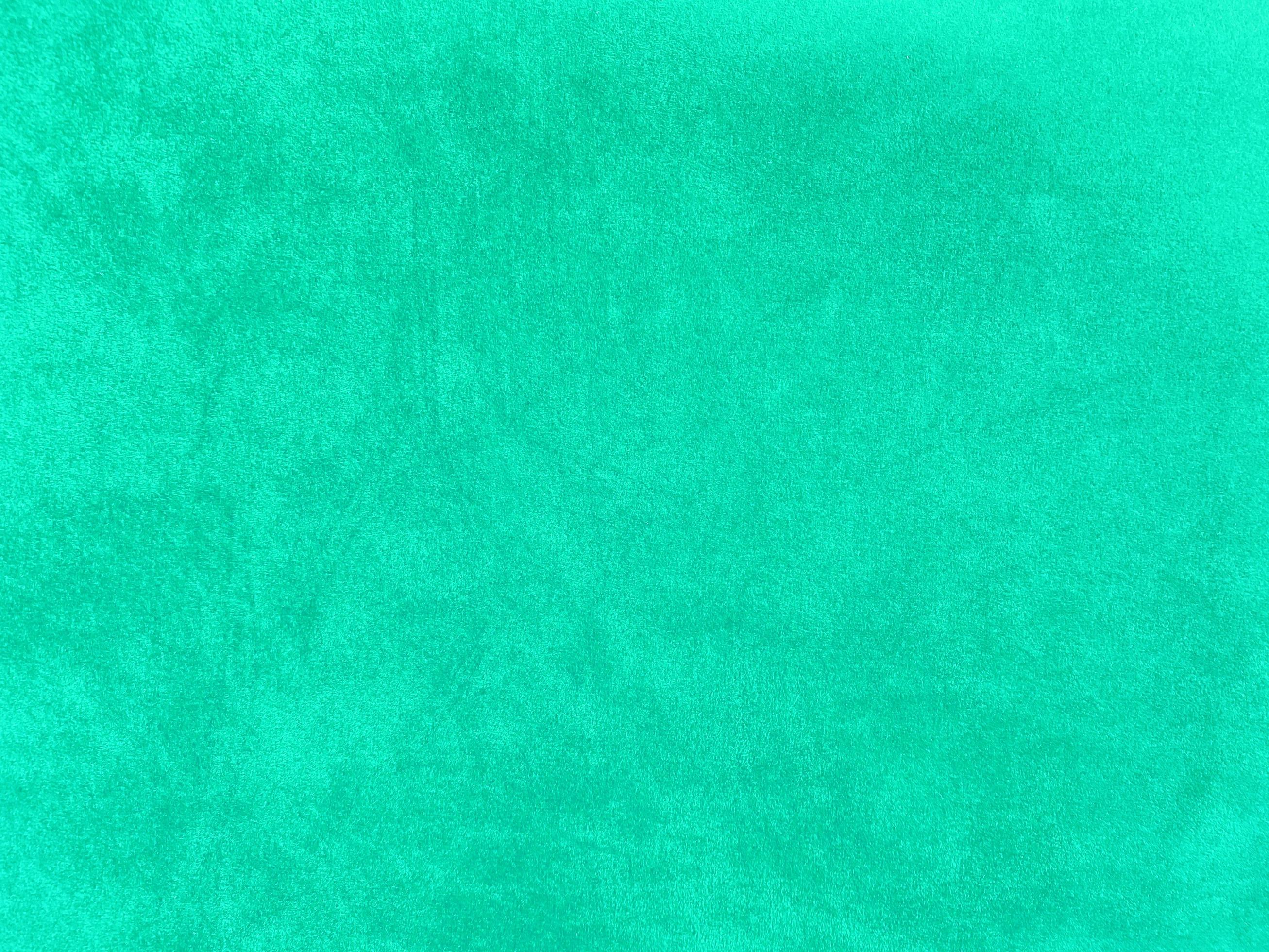 Mint green velvet fabric texture used as background. Empty green fabric