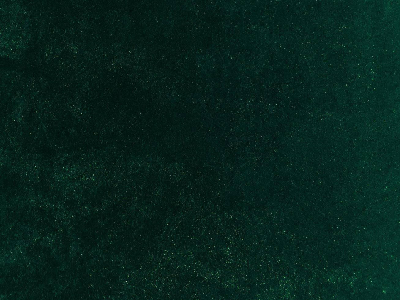 Dark green old velvet fabric texture used as background. Empty green