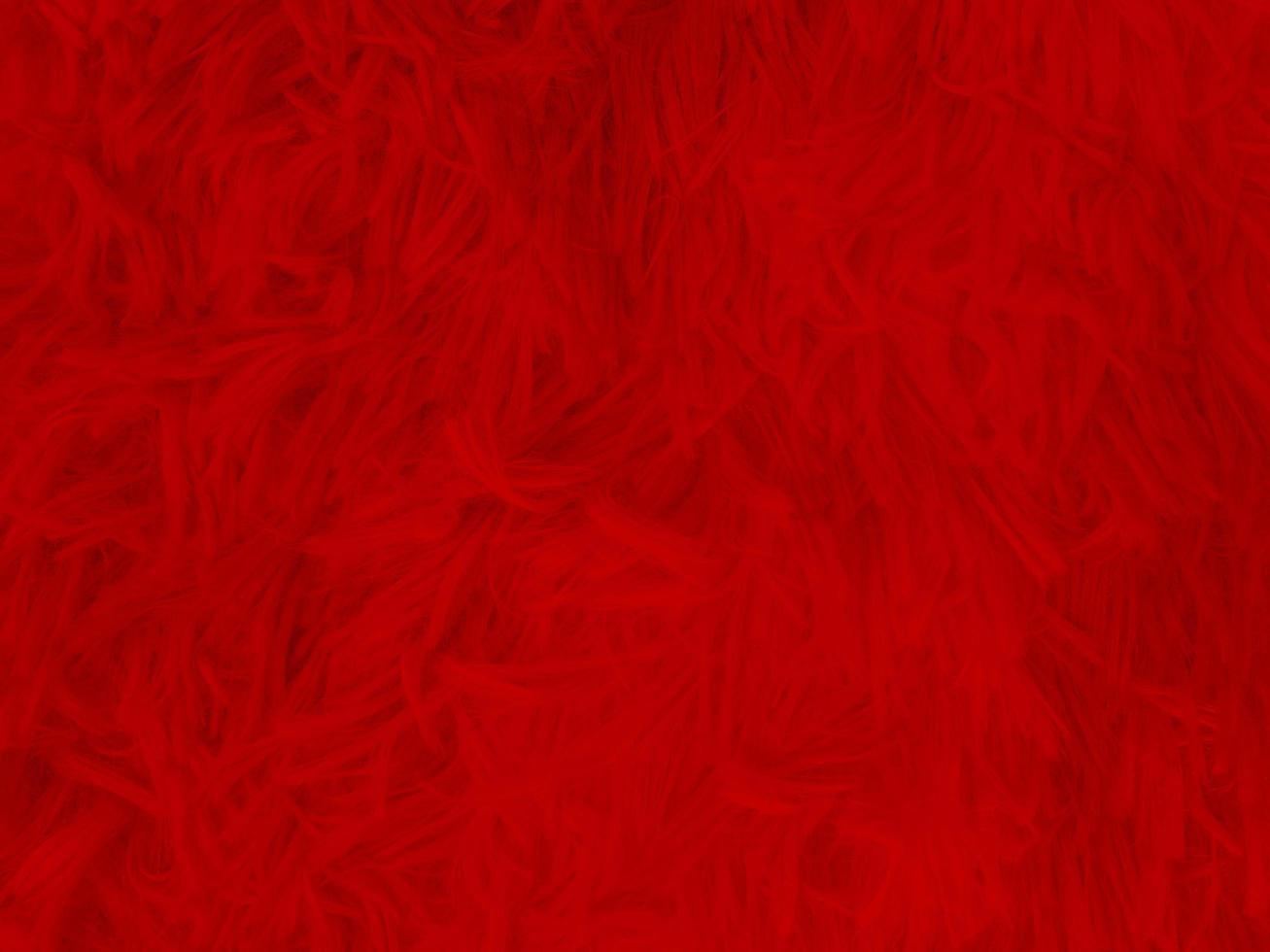 fondo de textura de lana limpia roja. lana de oveja natural ligera. algodón rojo sin costuras. textura de piel esponjosa para diseñadores el día de navidad. primer fragmento alfombra de lana roja.. foto