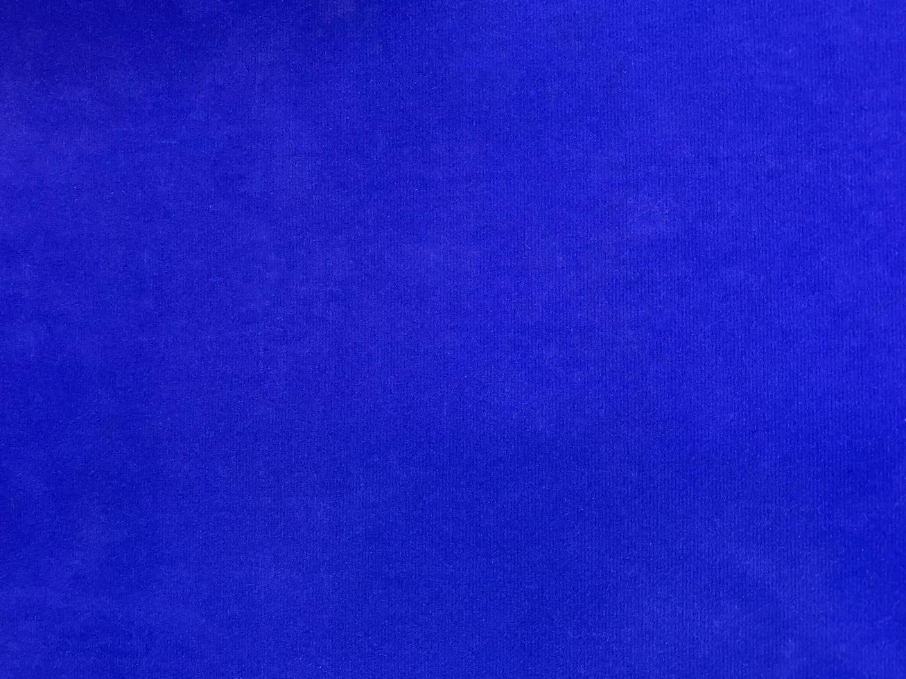 Blue velvet fabric texture used as background. Empty blue fabric