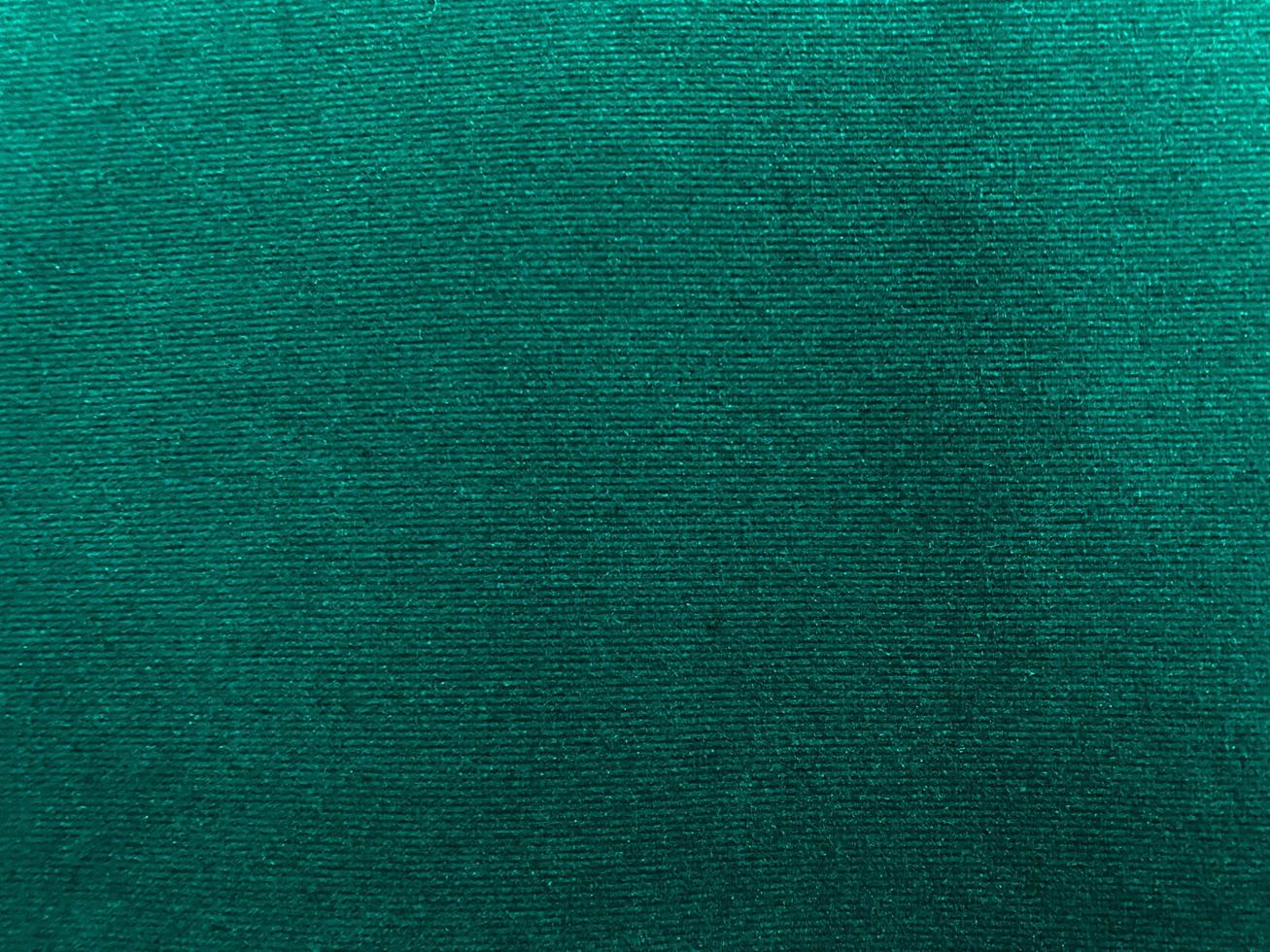 Dark green new velvet fabric texture used as background. Empty green fabric background of soft and smooth textile material. There is space for text.. photo