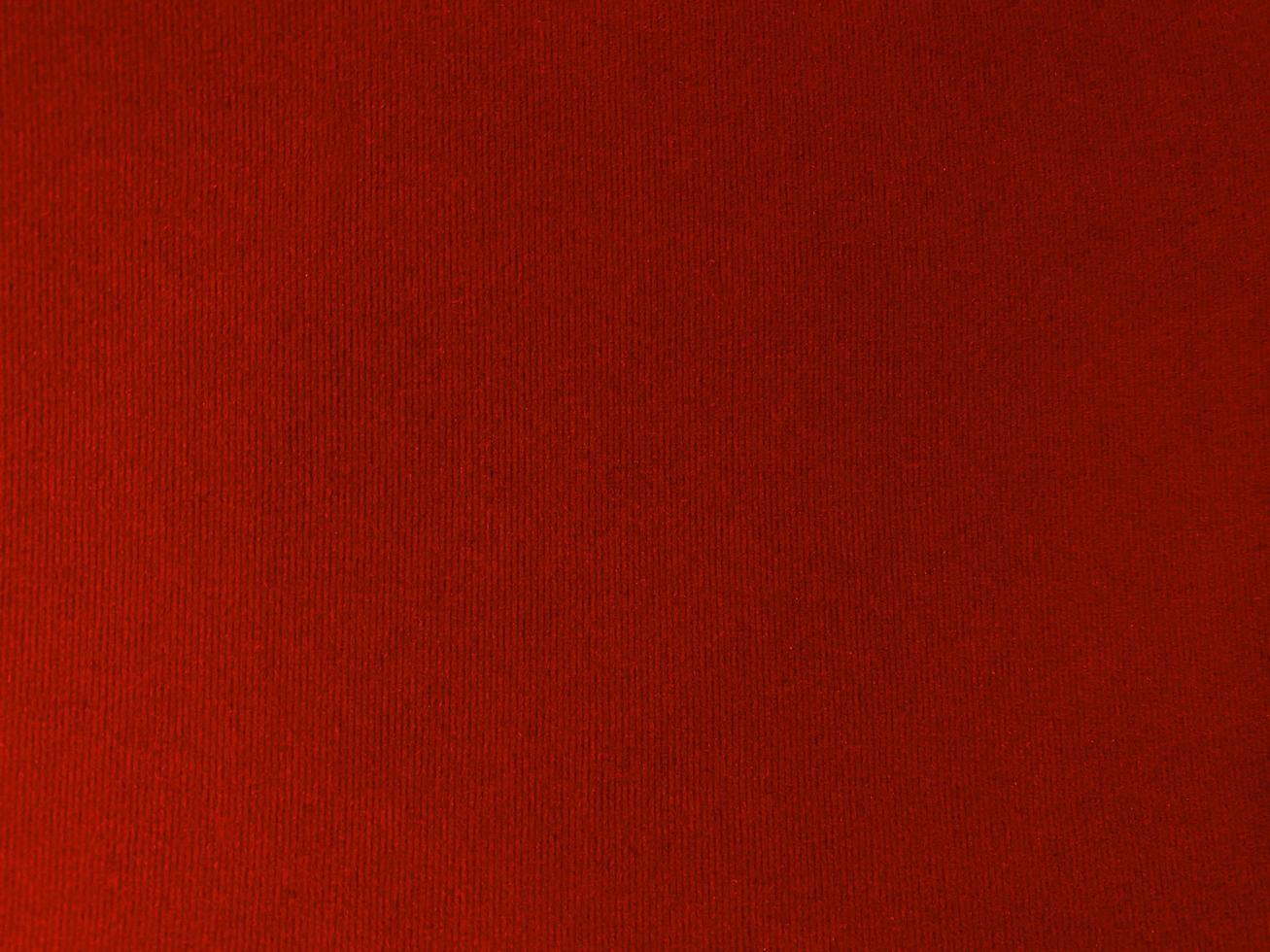 Dark red velvet fabric texture used as background. Empty dark red