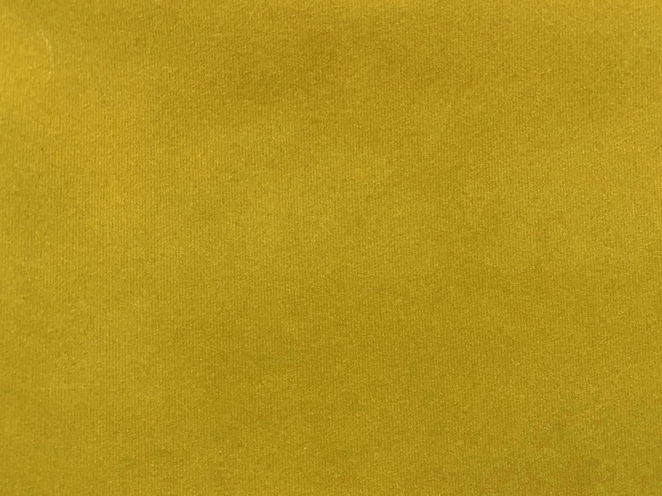 Yellow velvet fabric texture used as background. Empty yellow fabric