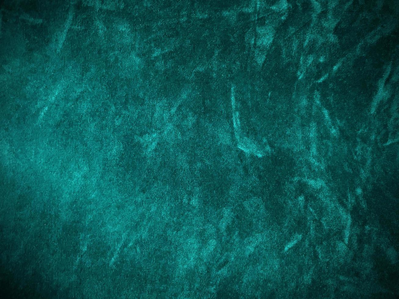 Dark green old velvet fabric texture used as background. Empty green fabric background of soft and smooth textile material. There is space for text.. photo