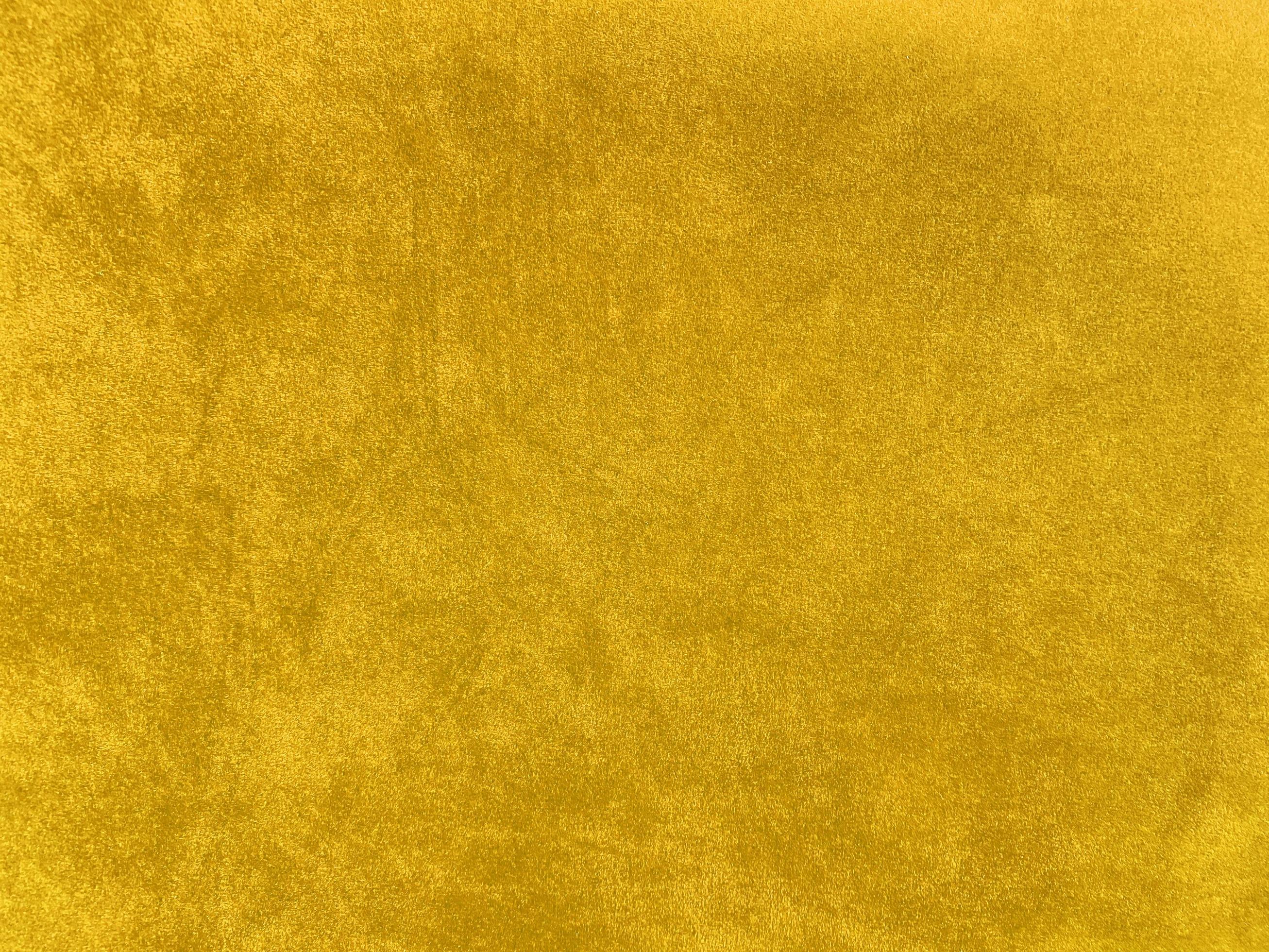 Yellow velvet fabric texture used as background. Empty yellow fabric