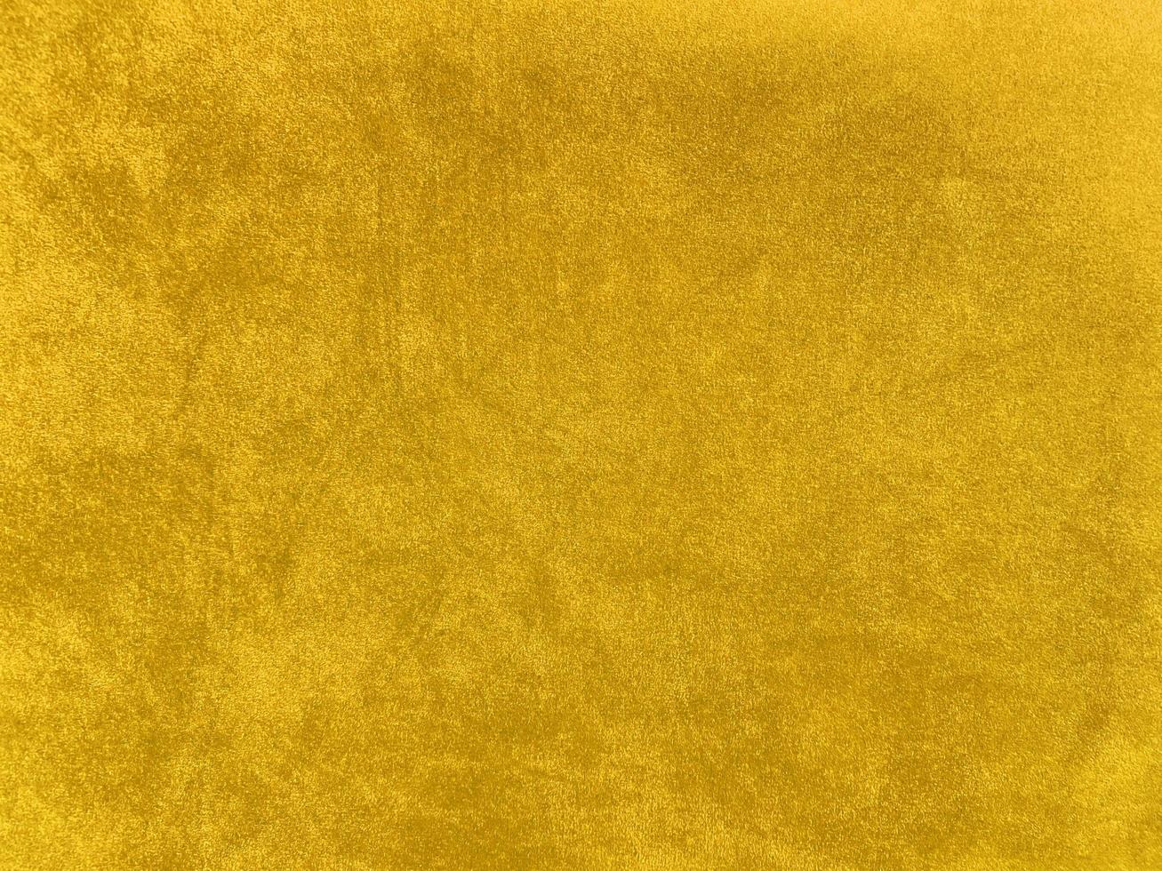 Yellow velvet fabric texture used as background. Empty yellow fabric