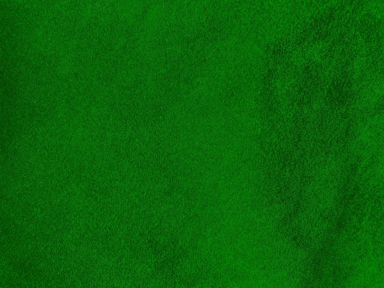Dark green old velvet fabric texture used as background. Empty green fabric background of soft and smooth textile material. There is space for text.. photo