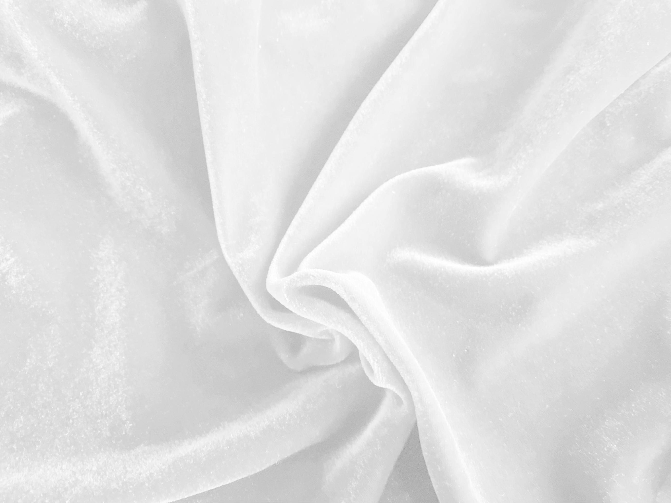 White velvet fabric texture used as background. Empty white fabric