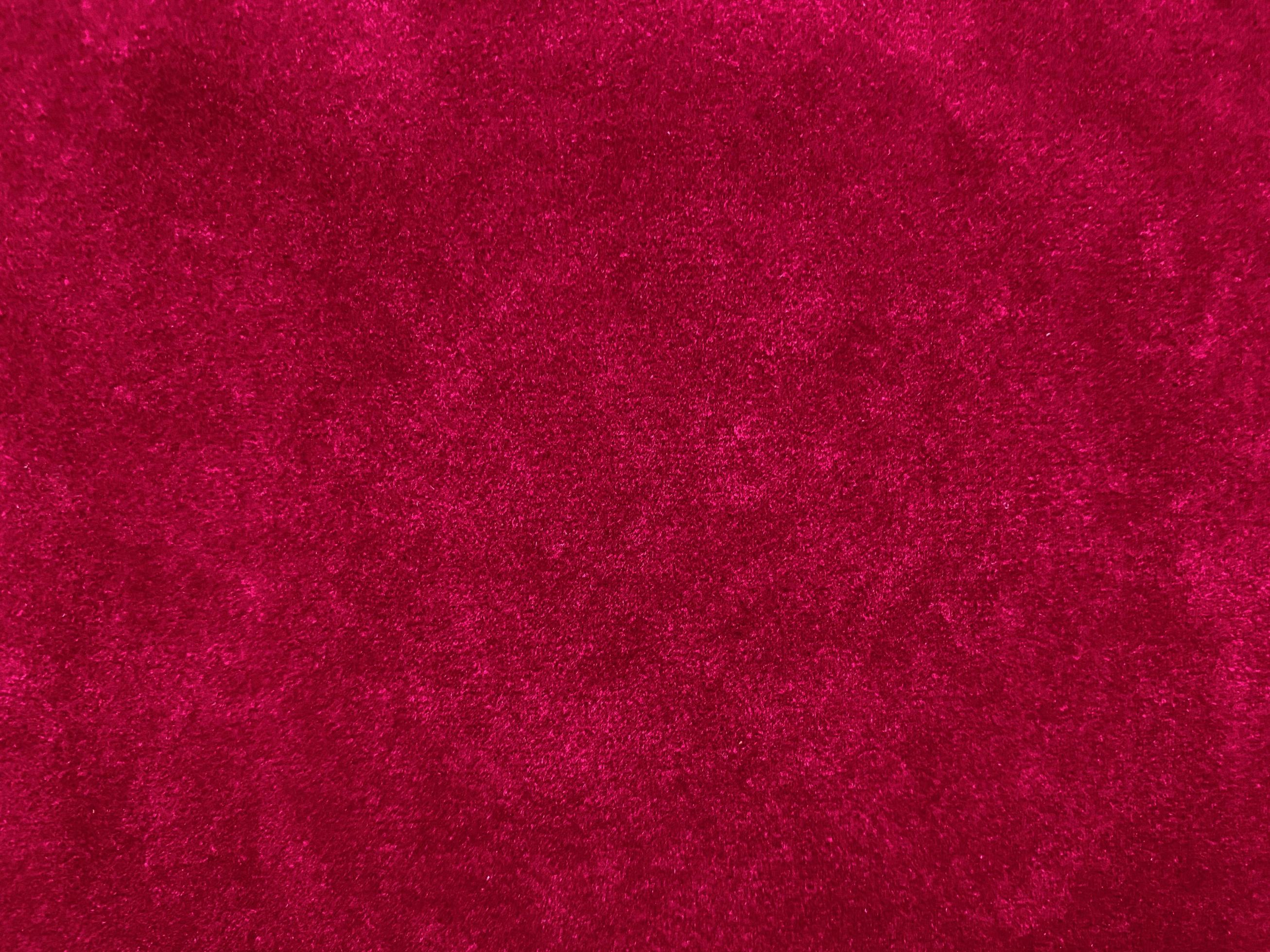 Red old velvet fabric texture used as background. Empty red fabric