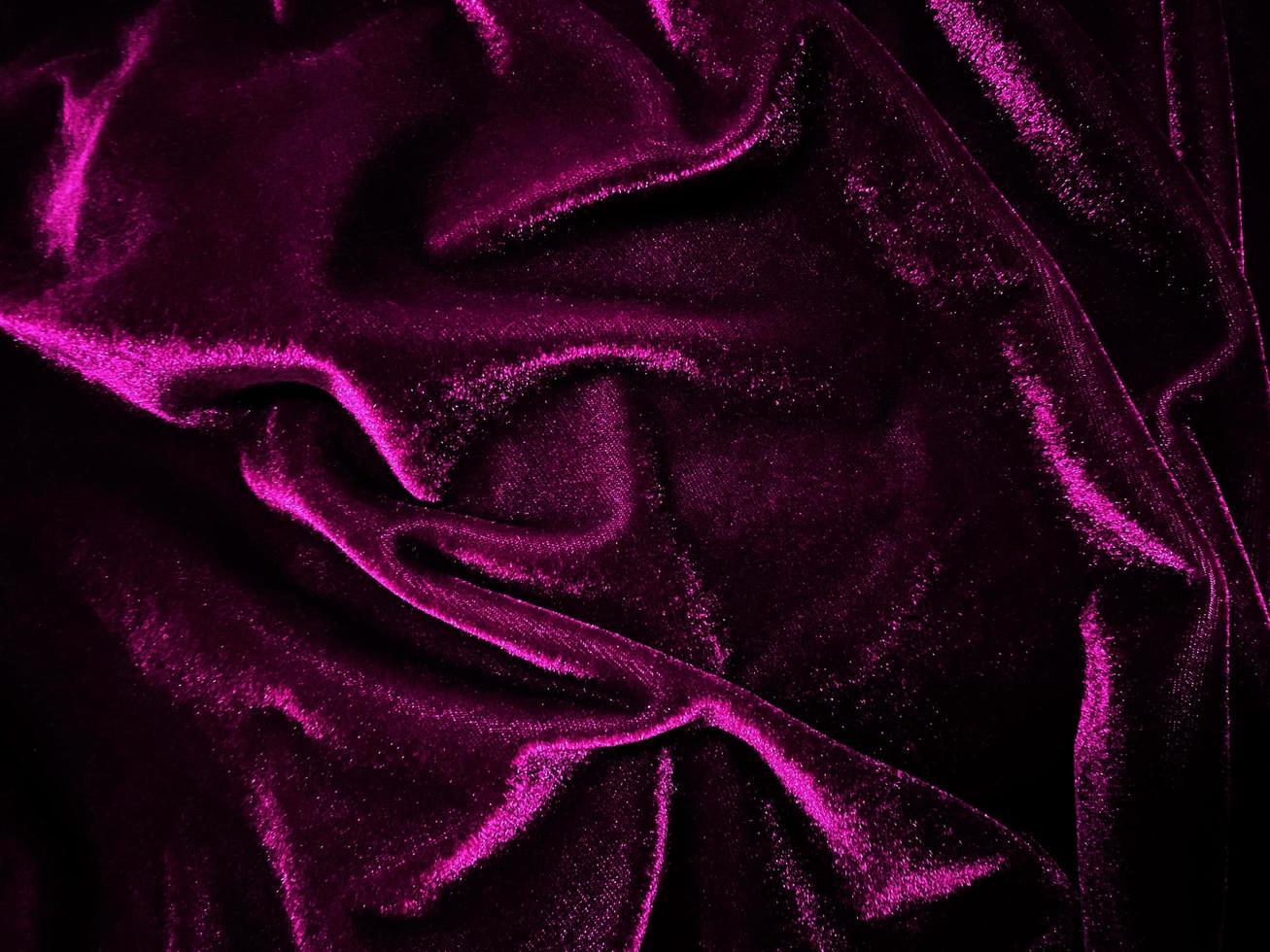 Magenta velvet fabric texture used as background. Empty magenta fabric