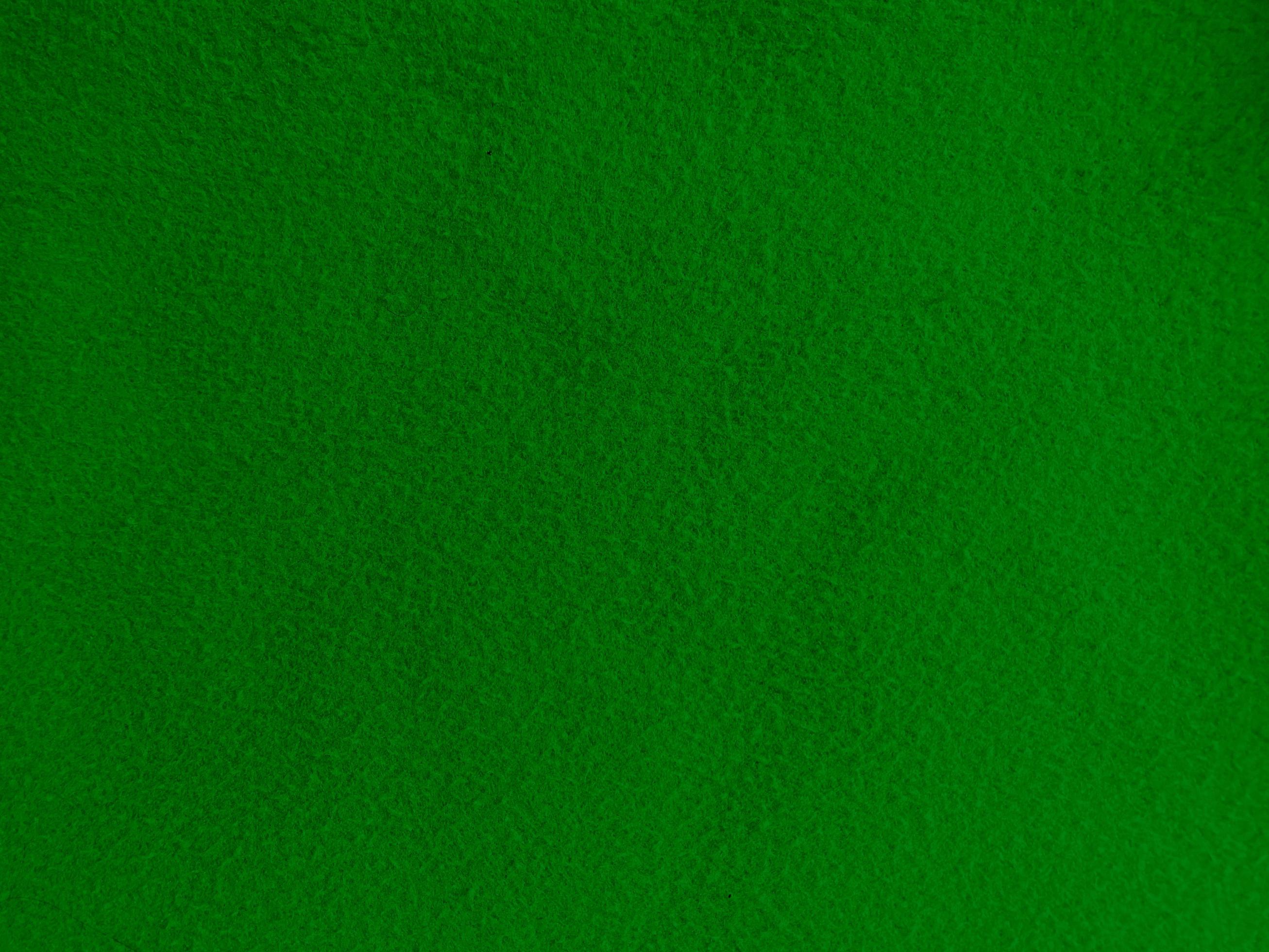 Felt green soft rough textile material background texture close up