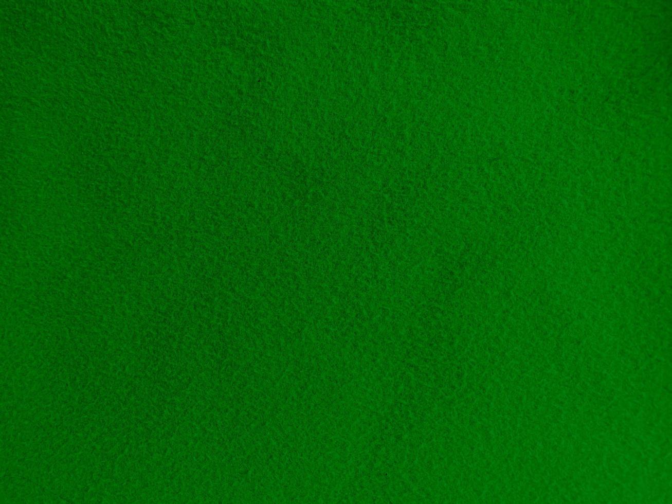 Felt green soft rough textile material background texture close up,poker table,tennis ball,table cloth. Empty green fabric background. photo