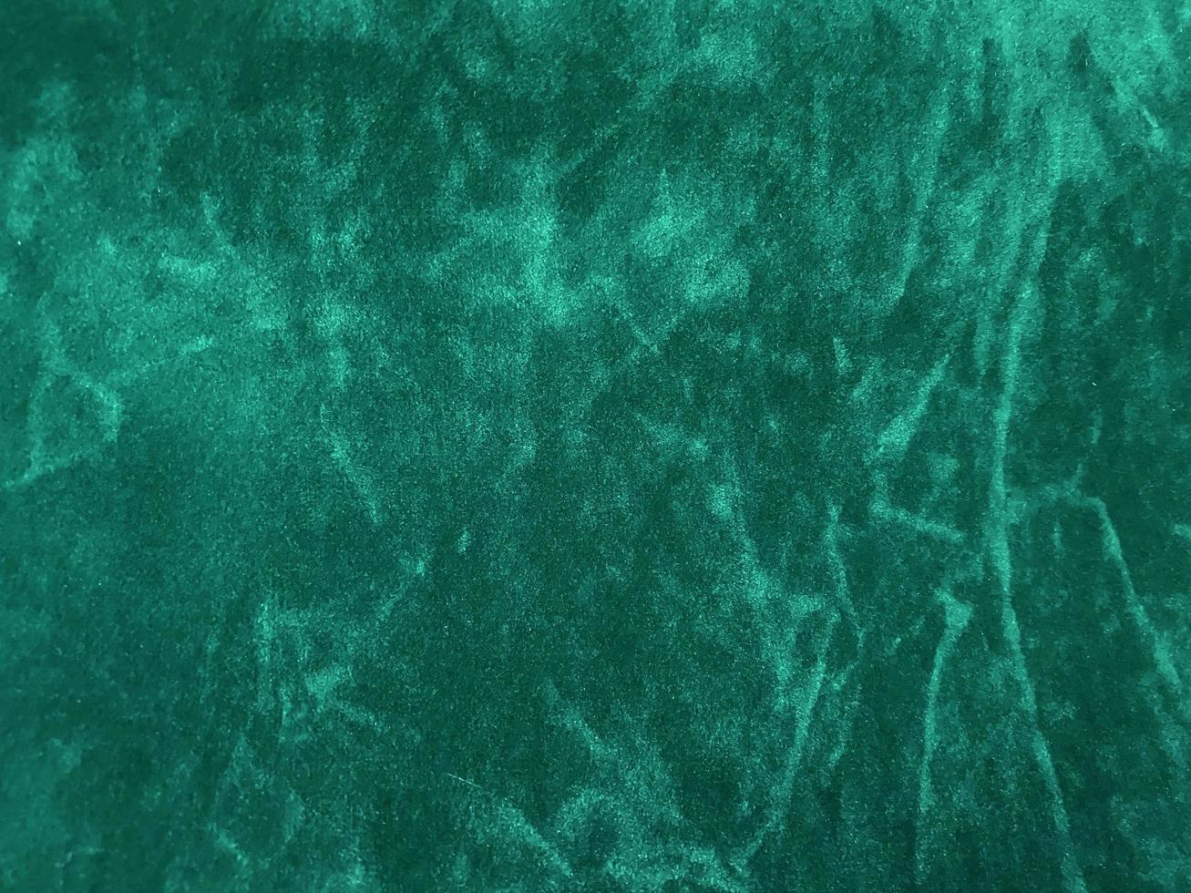 Dark green old velvet fabric texture used as background. Empty green