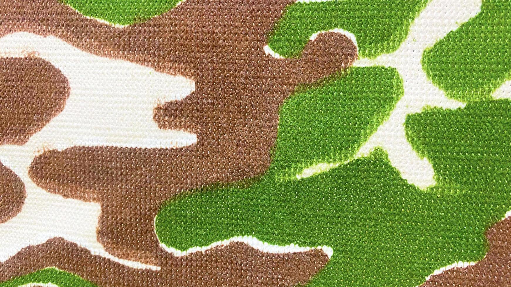 Military pattern cloth texture There are stripes of fibers of the fabric, green brown white tone. Use this for wallpaper or background image. There is a blank space for text. photo