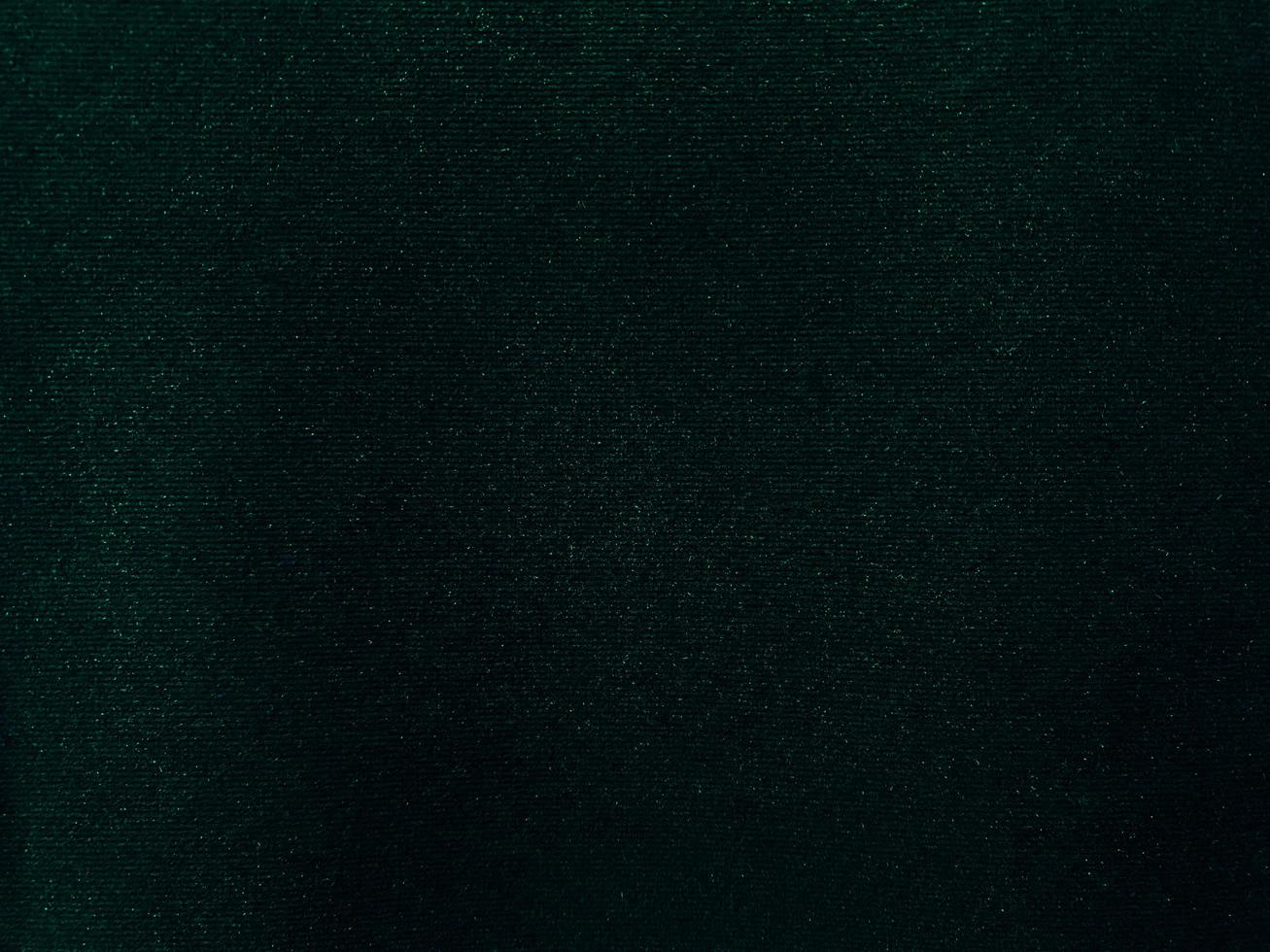 Dark green old velvet fabric texture used as background. Empty green fabric background of soft and smooth textile material. There is space for text.. photo