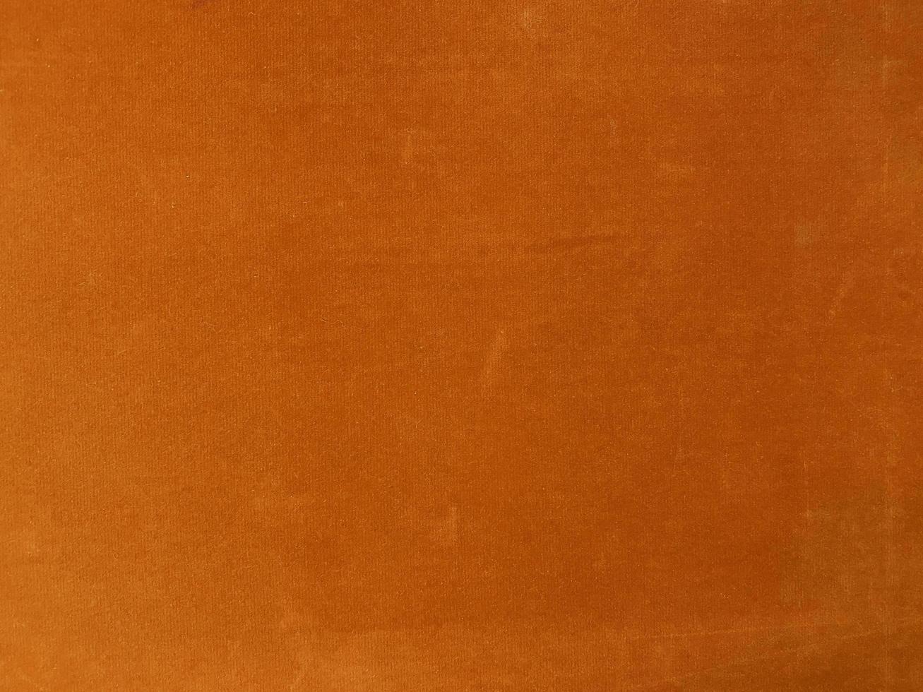 Orange velvet fabric texture used as background. Empty orange fabric background of soft and smooth textile material. There is space for text. photo