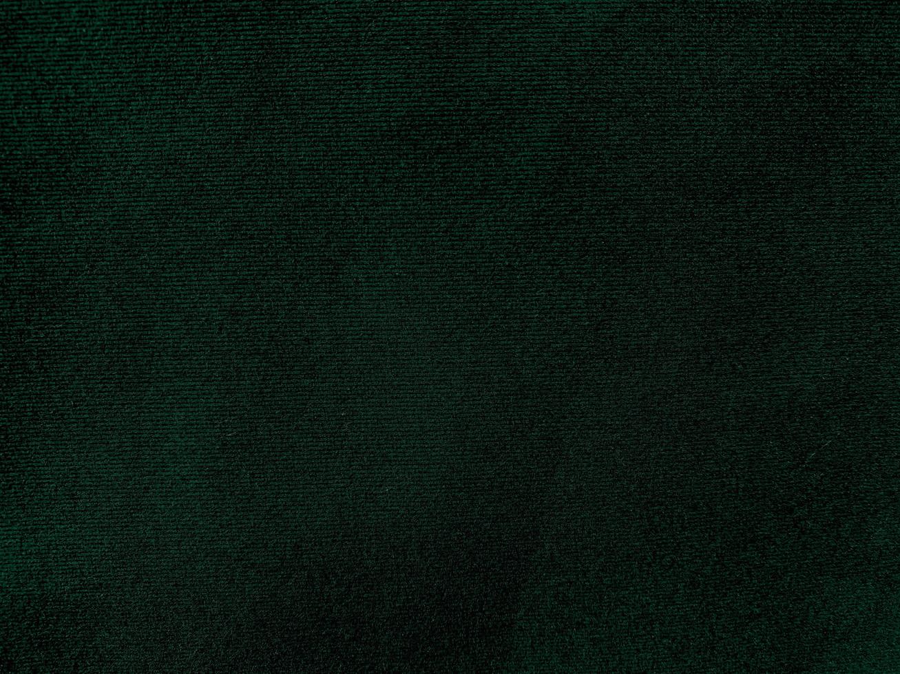 Dark green old velvet fabric texture used as background. Empty green fabric background of soft and smooth textile material. There is space for text. photo