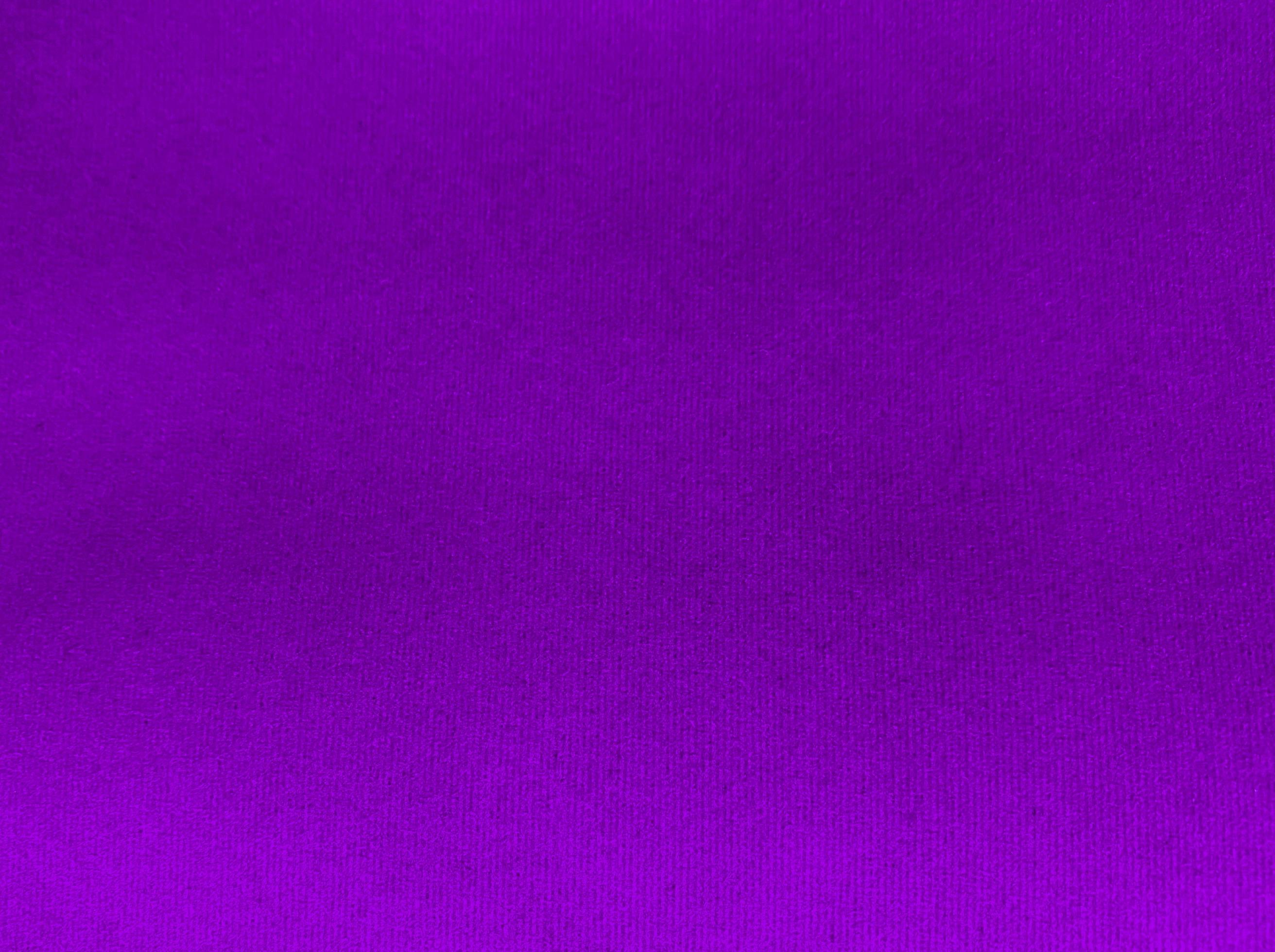 Purple velvet fabric texture used as background. Empty purple fabric