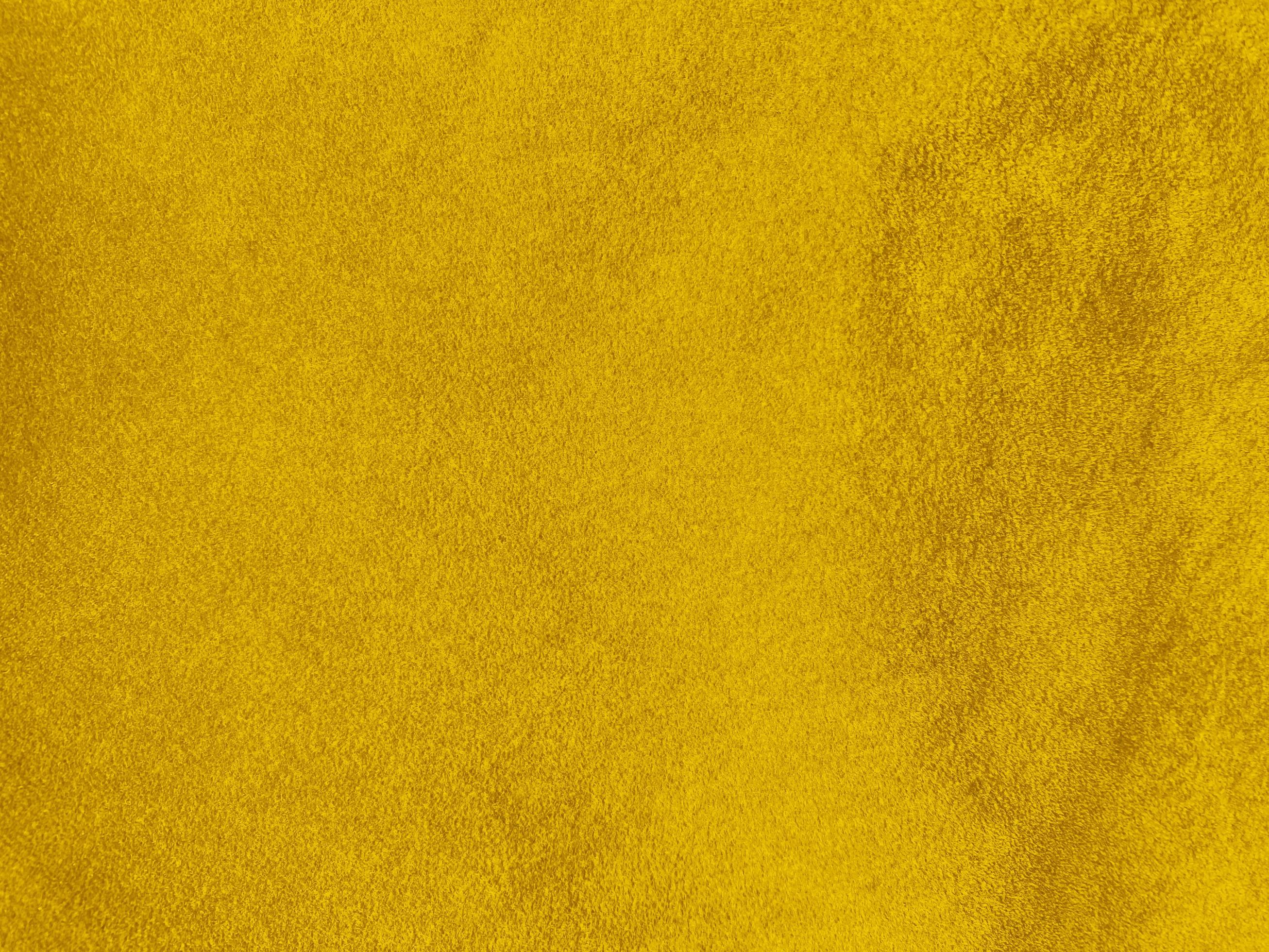 Yellow velvet fabric texture used as background. Empty yellow fabric